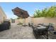 Cozy patio with stylish outdoor seating, stone pavers, and lush landscaping, creating a tranquil outdoor retreat at 1444 E Myrna Ln, Tempe, AZ 85284