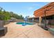 Backyard features a spacious pool, patio umbrellas, lounge seating, and a safety fence at 1444 E Myrna Ln, Tempe, AZ 85284
