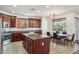 A kitchen with granite countertops, stainless steel appliances, and a center island perfect for cooking and entertaining at 14744 W Poinsettia Dr, Surprise, AZ 85379
