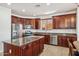 Well-equipped kitchen with stainless steel appliances, granite countertops, and custom wood cabinets at 14744 W Poinsettia Dr, Surprise, AZ 85379