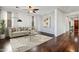 Bright living room with hardwood floors, stylish rug, and large windows providing natural light at 14744 W Poinsettia Dr, Surprise, AZ 85379