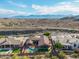 Stunning aerial view showcasing a home with a sparkling pool, set against a beautiful desert and mountain backdrop at 14841 S 6Th Pl, Phoenix, AZ 85048