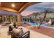 Relaxing covered back patio, complete with a pristine pool and mountain views at 14841 S 6Th Pl, Phoenix, AZ 85048