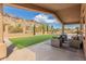 Covered patio with outdoor seating area overlooking the backyard, pool, and mountain views at 14841 S 6Th Pl, Phoenix, AZ 85048