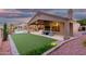Lush backyard with a pool, outdoor seating, and a well-maintained lawn at 14841 S 6Th Pl, Phoenix, AZ 85048