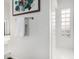 Bright bathroom hallway featuring a decorative artwork and accent glass block wall at 14841 S 6Th Pl, Phoenix, AZ 85048