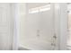 Bathroom featuring a bathtub with showerhead and window for natural lighting at 14841 S 6Th Pl, Phoenix, AZ 85048