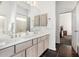 Bathroom featuring double sinks, a mirror, and a view to the bedroom at 14841 S 6Th Pl, Phoenix, AZ 85048