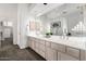 Bathroom vanity area with dual sinks, white cabinets, and a large mirror at 14841 S 6Th Pl, Phoenix, AZ 85048