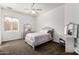 Cozy bedroom with a ceiling fan, carpet and window provides natural light at 14841 S 6Th Pl, Phoenix, AZ 85048