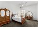 Charming bedroom with vintage furniture, including a carved bed and dresser with mirrors at 14841 S 6Th Pl, Phoenix, AZ 85048