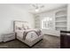 Bright bedroom with a comfortable bed, arched shelving, and neutral color palette at 14841 S 6Th Pl, Phoenix, AZ 85048
