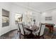 Elegant dining room featuring a chandelier, marble table, and views of the desert landscape at 14841 S 6Th Pl, Phoenix, AZ 85048