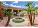 A classic fountain serves as the focal point, framed by swaying palms at 14841 S 6Th Pl, Phoenix, AZ 85048