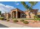 Beautiful desert home with manicured landscaping, an arched entrance, and a barrel tile roof at 14841 S 6Th Pl, Phoenix, AZ 85048