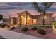 Beautiful single-story home with an arched entryway, desert landscaping, and exterior lighting at 14841 S 6Th Pl, Phoenix, AZ 85048