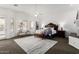 Large primary bedroom with a decorative headboard, neutral tones, and ample natural light at 14841 S 6Th Pl, Phoenix, AZ 85048