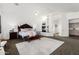 Primary bedroom boasts a fireplace, decorative headboard, and neutral tones at 14841 S 6Th Pl, Phoenix, AZ 85048