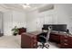 Bright office with a ceiling fan, modern desk, and shelving at 14841 S 6Th Pl, Phoenix, AZ 85048