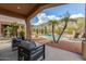 The covered patio offers a comfortable space to relax while enjoying the beautiful pool at 14841 S 6Th Pl, Phoenix, AZ 85048