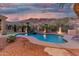 Inviting pool with a rock waterfall feature and desert landscaping, perfect for relaxing evenings at 14841 S 6Th Pl, Phoenix, AZ 85048