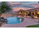 Gorgeous backyard with a freeform pool, rock waterfall, and covered patio area at 14841 S 6Th Pl, Phoenix, AZ 85048