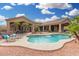 An inviting pool with mature palms surrounds this home, creating the perfect outdoor oasis at 14841 S 6Th Pl, Phoenix, AZ 85048