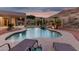 Beautiful backyard pool with desert landscape, palm trees, and lounge chairs at 14841 S 6Th Pl, Phoenix, AZ 85048
