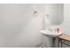 Powder room features a pedestal sink, large mirror, and wall-mounted towel holder at 14841 S 6Th Pl, Phoenix, AZ 85048