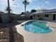 View of backyard pool and rock landscaping, featuring a storage shed in the background at 1545 W Marco Polo Rd, Phoenix, AZ 85027