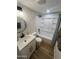 Bathroom with a shower-tub combo, white vanity, and modern fixtures at 1545 W Marco Polo Rd, Phoenix, AZ 85027