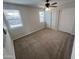 Bright bedroom featuring new carpet, a ceiling fan, and closet doors at 1545 W Marco Polo Rd, Phoenix, AZ 85027