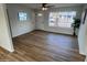 Cozy living room featuring wood-look flooring, a large window, and a front door with a window at 1545 W Marco Polo Rd, Phoenix, AZ 85027