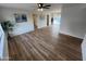 Bright living room with modern ceiling fan, wood-look flooring, and views to the backyard pool at 1545 W Marco Polo Rd, Phoenix, AZ 85027