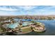 Scenic aerial view showcasing the community pool and lake, surrounded by desert landscaping at 16139 S 178Th Dr, Goodyear, AZ 85338