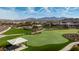 Beautiful community putting green and park with mountain views, walking paths, covered picnic area, and lush landscaping at 16139 S 178Th Dr, Goodyear, AZ 85338