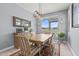 Bright dining room with a wooden table, plaid chairs, and a large window with views of the outdoors at 16139 S 178Th Dr, Goodyear, AZ 85338