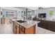 Open-concept kitchen with granite island, stainless steel sink, and seamless flow to dining and living areas at 16139 S 178Th Dr, Goodyear, AZ 85338