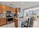 Modern kitchen with stainless steel appliances, granite countertops, a spacious island and barstool seating at 16139 S 178Th Dr, Goodyear, AZ 85338