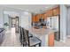 Bright, modern kitchen features a large center island with seating, stainless steel appliances, and wood cabinetry at 16139 S 178Th Dr, Goodyear, AZ 85338