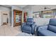 Comfortable living space with plush blue chairs, a glass cabinet, and views of the open-concept kitchen at 16139 S 178Th Dr, Goodyear, AZ 85338