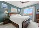 Serene bedroom features a king-size bed, soft lighting, and a large window offering backyard views at 16139 S 178Th Dr, Goodyear, AZ 85338
