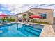 Inviting backyard with a pool, sun loungers, and an outdoor seating area under a covered patio at 16139 S 178Th Dr, Goodyear, AZ 85338