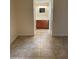 Hallway view of a bathroom with a single sink vanity and tile flooring at 16602 N 25Th St # 129, Phoenix, AZ 85032