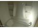 Bathroom featuring a full-size tub/shower combo with built-in shelves for toiletries at 16602 N 25Th St # 129, Phoenix, AZ 85032