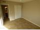 Neutral-toned bedroom with tile flooring, closet, and ensuite bathroom entrance at 16602 N 25Th St # 129, Phoenix, AZ 85032