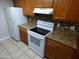 Clean kitchen with modern appliances, tile backsplash, and warm wood cabinetry at 16602 N 25Th St # 129, Phoenix, AZ 85032