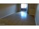 Living room with sliding glass door to balcony and tile flooring at 16602 N 25Th St # 129, Phoenix, AZ 85032