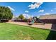Community playground area featuring swings, slides, and climbing structures, surrounded by green grass and trees at 16602 N 25Th St # 129, Phoenix, AZ 85032