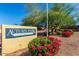 Autumn Park Condominiums sign with lush red flowers and greenery at 16602 N 25Th St # 129, Phoenix, AZ 85032